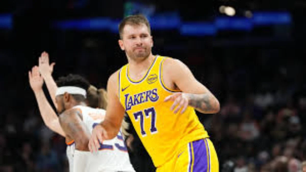 Luka Doncic in a yellow Los Angeles Lakers uniform playing against the Knicks