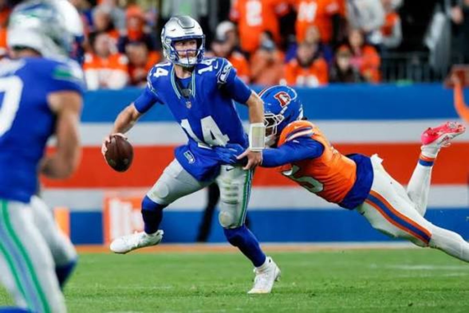 Seattle quarterback Sam Darnold under pressure from the Denver defense