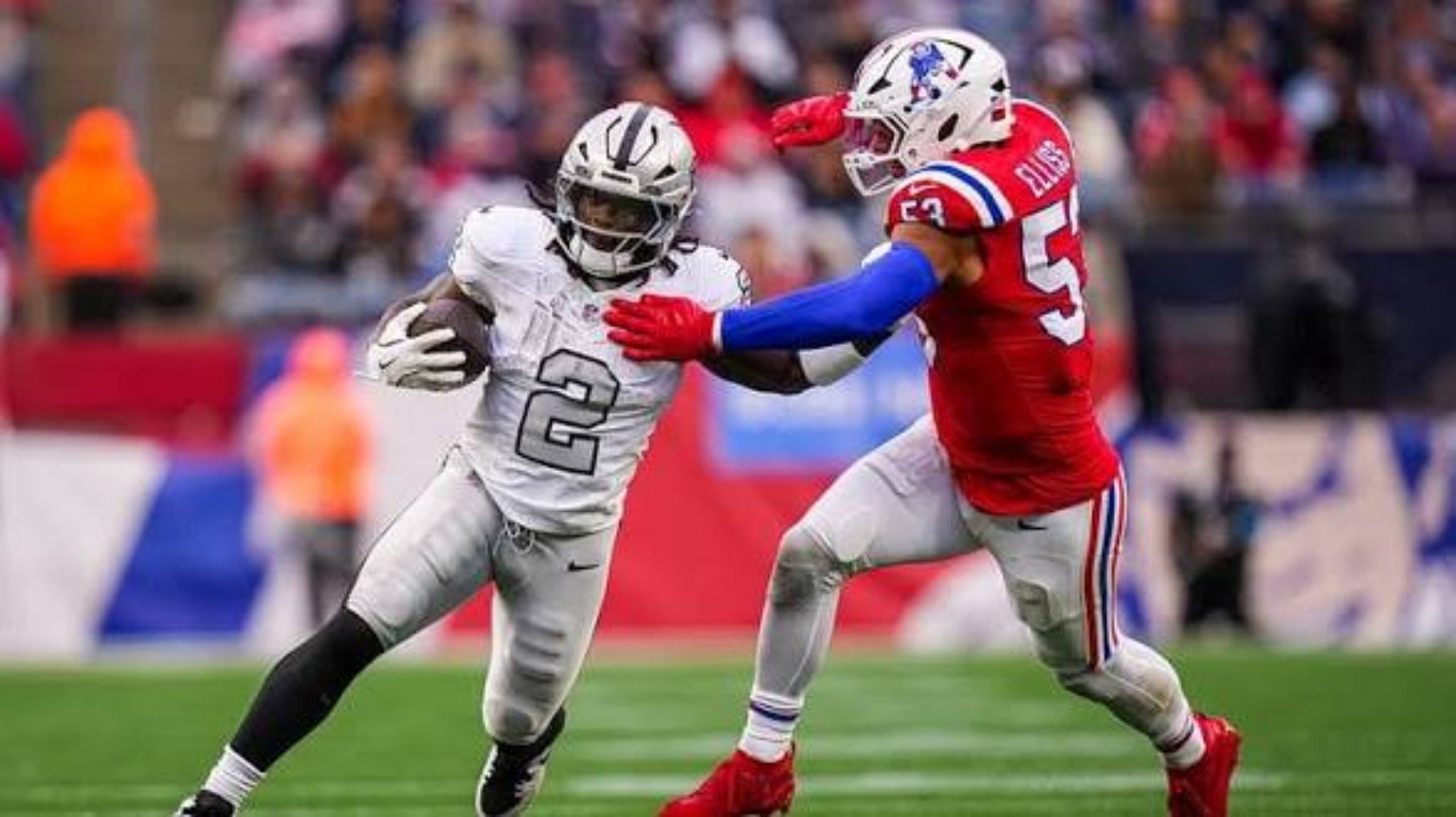 User-supplied NFL action photo of a Raiders ballcarrier against a Patriots defender
