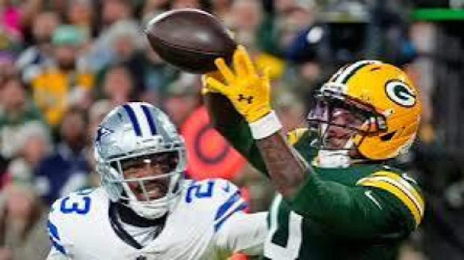 Green Bay Packers receiver making a catch with a Dallas Cowboys defender nearby