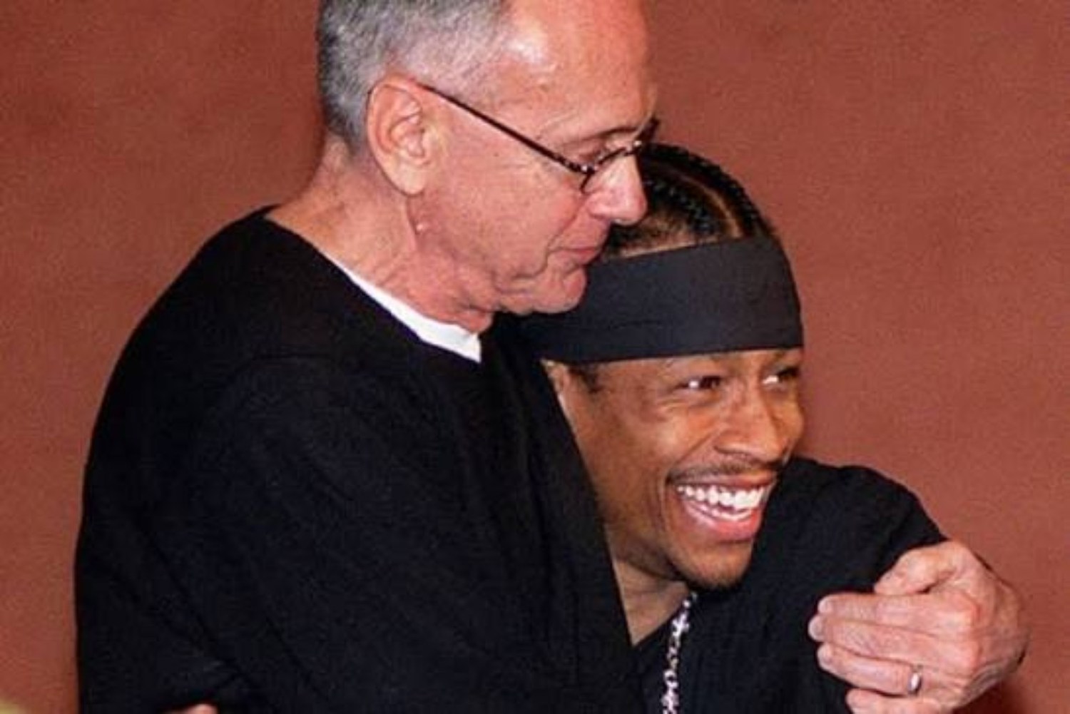 A veteran NBA coach sharing a relaxed moment with his star guard