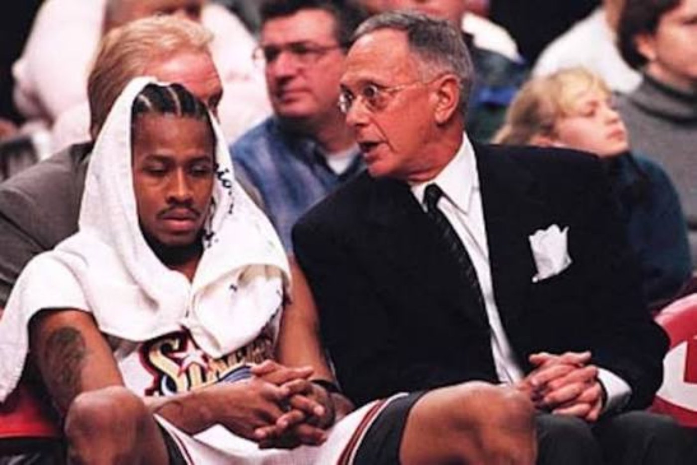 Allen Iverson seated on the Philadelphia 76ers bench beside head coach Larry Brown