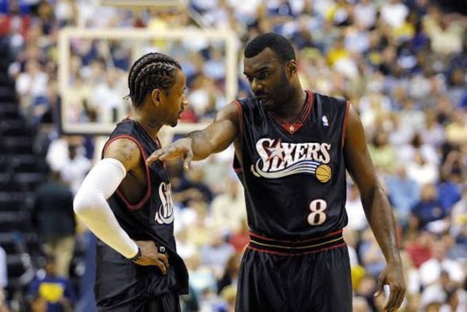 Two Philadelphia 76ers teammates discussing positioning on the court