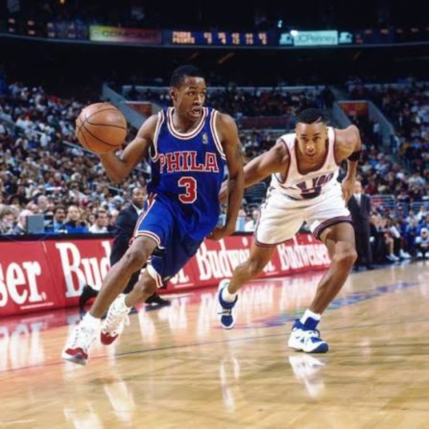 Allen Iverson attacking off the dribble in a blue Philadelphia 76ers uniform during his rookie season