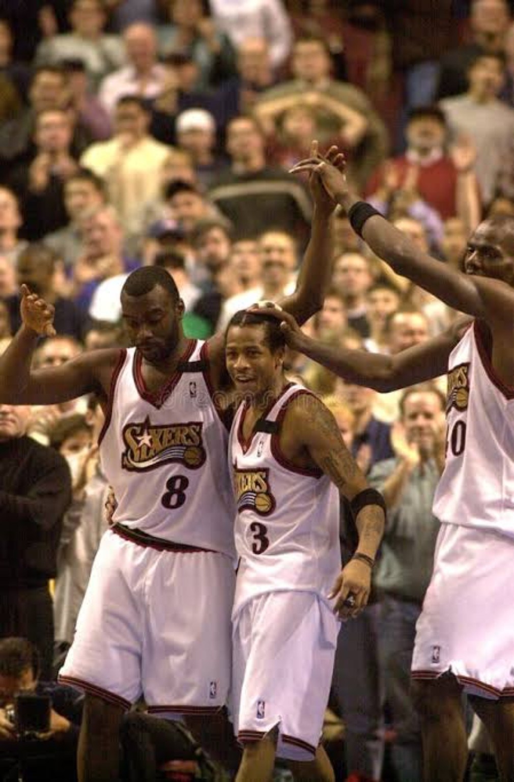 Philadelphia 76ers players celebrating together during the late-1990s and early-2000s era
