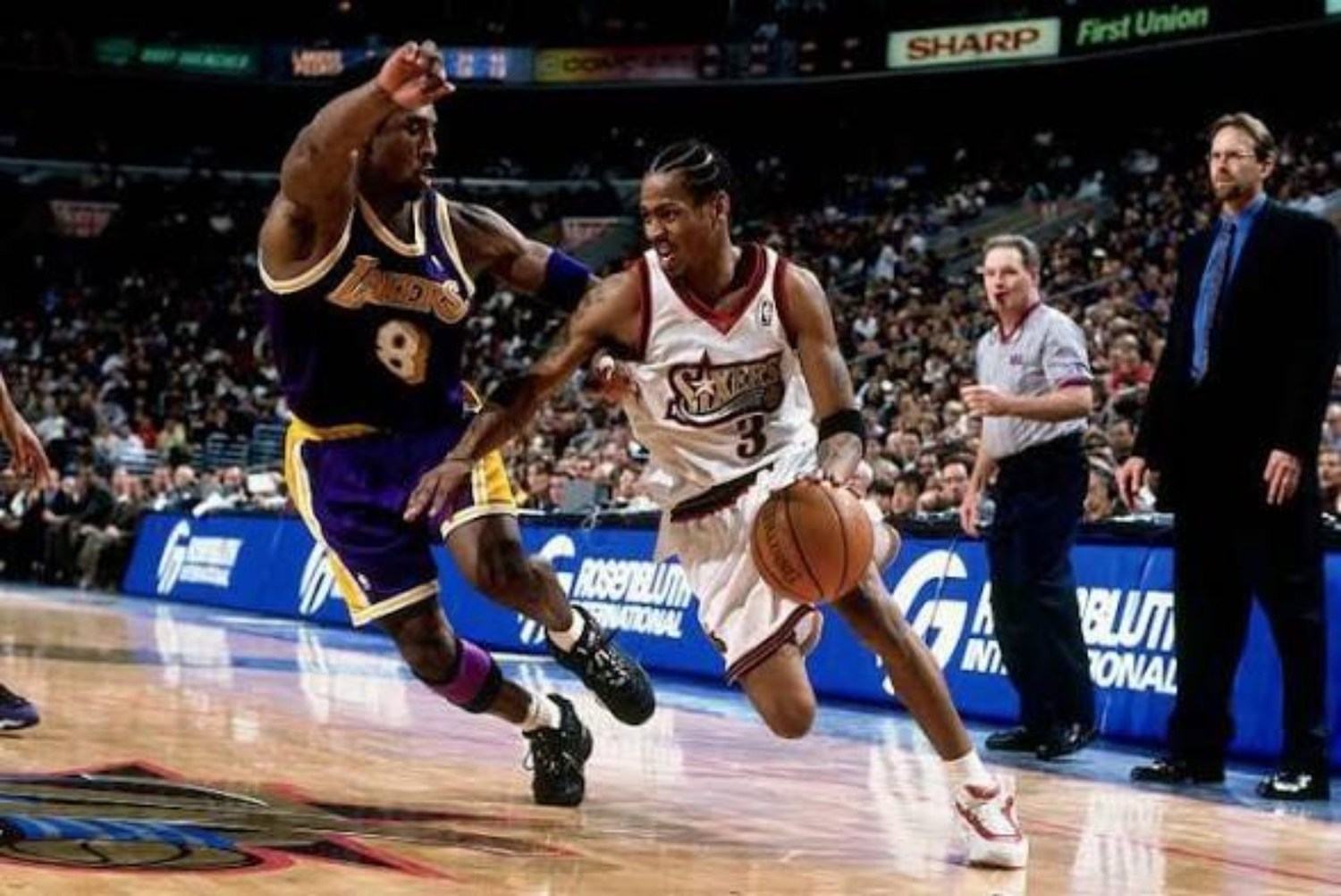 Philadelphia 76ers guard attacking off the dribble against a Los Angeles defender