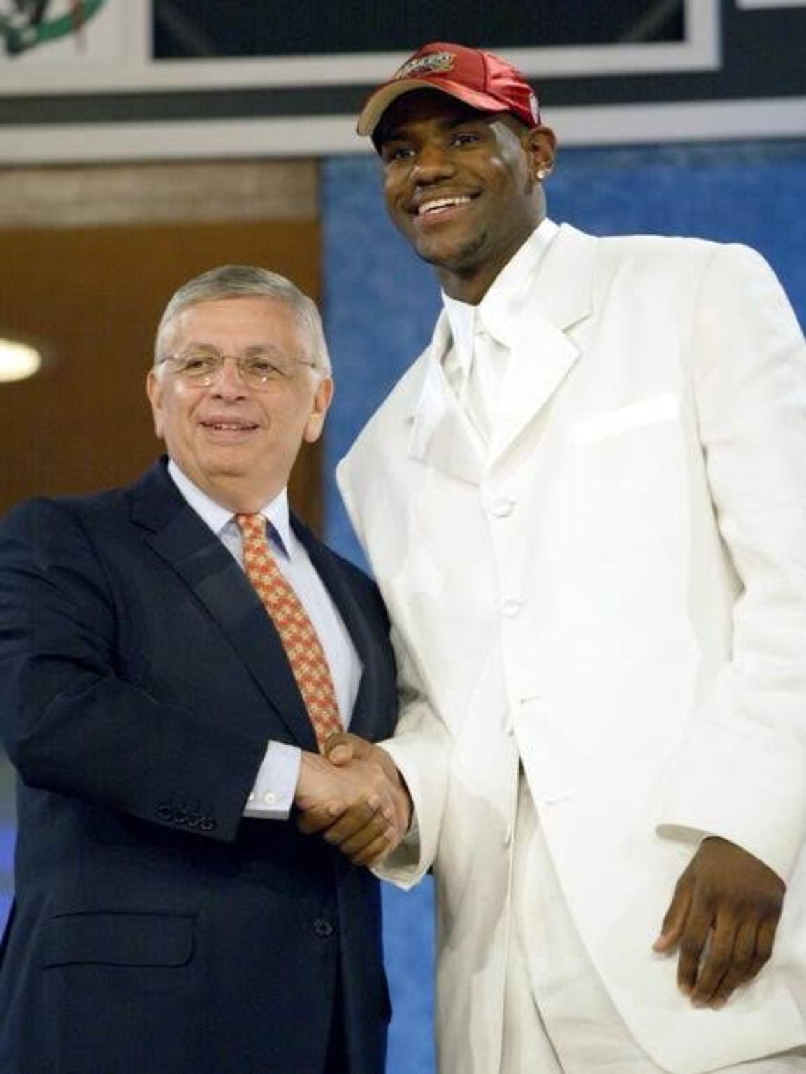 LeBron James in a white suit shaking hands with NBA commissioner David Stern at the 2003 draft