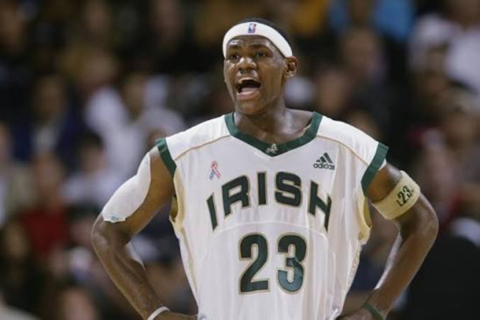 Teenage LeBron James wearing a white Fighting Irish jersey number 23