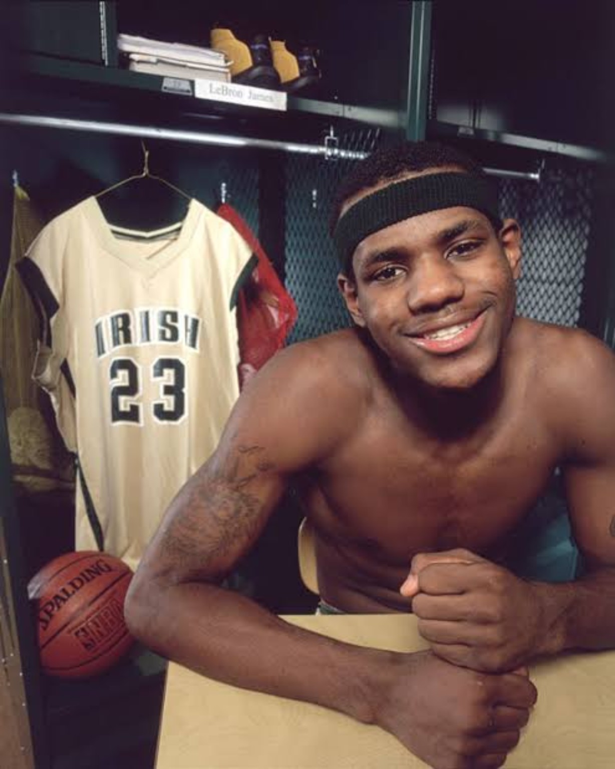 LeBron James smiling in a high-school basketball locker room beside an Irish jersey