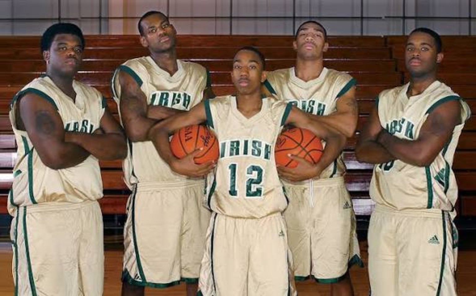 St. Vincent–St. Mary basketball players posing together inside a gym
