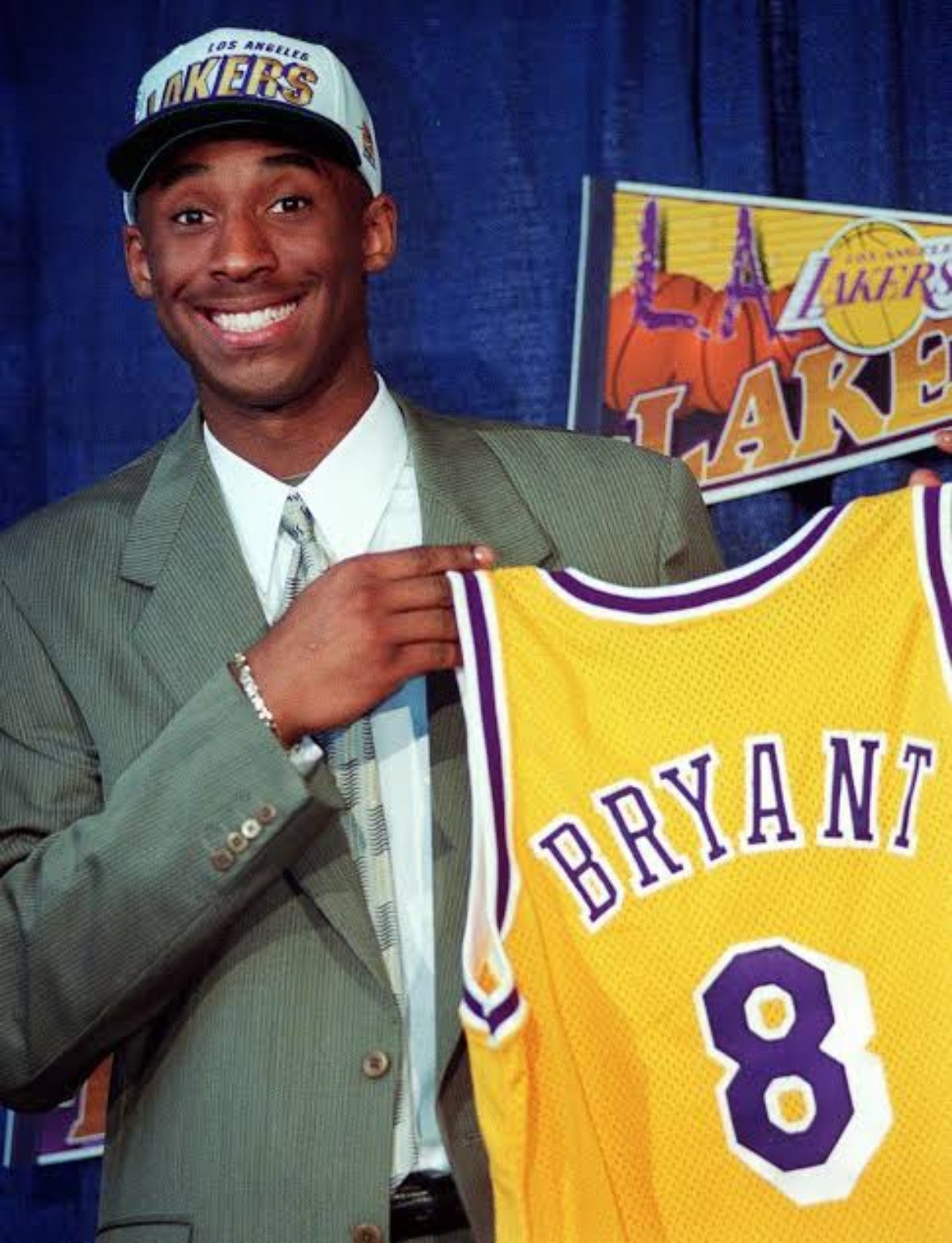 Kobe Bryant on draft night holding a Los Angeles Lakers number 8 jersey