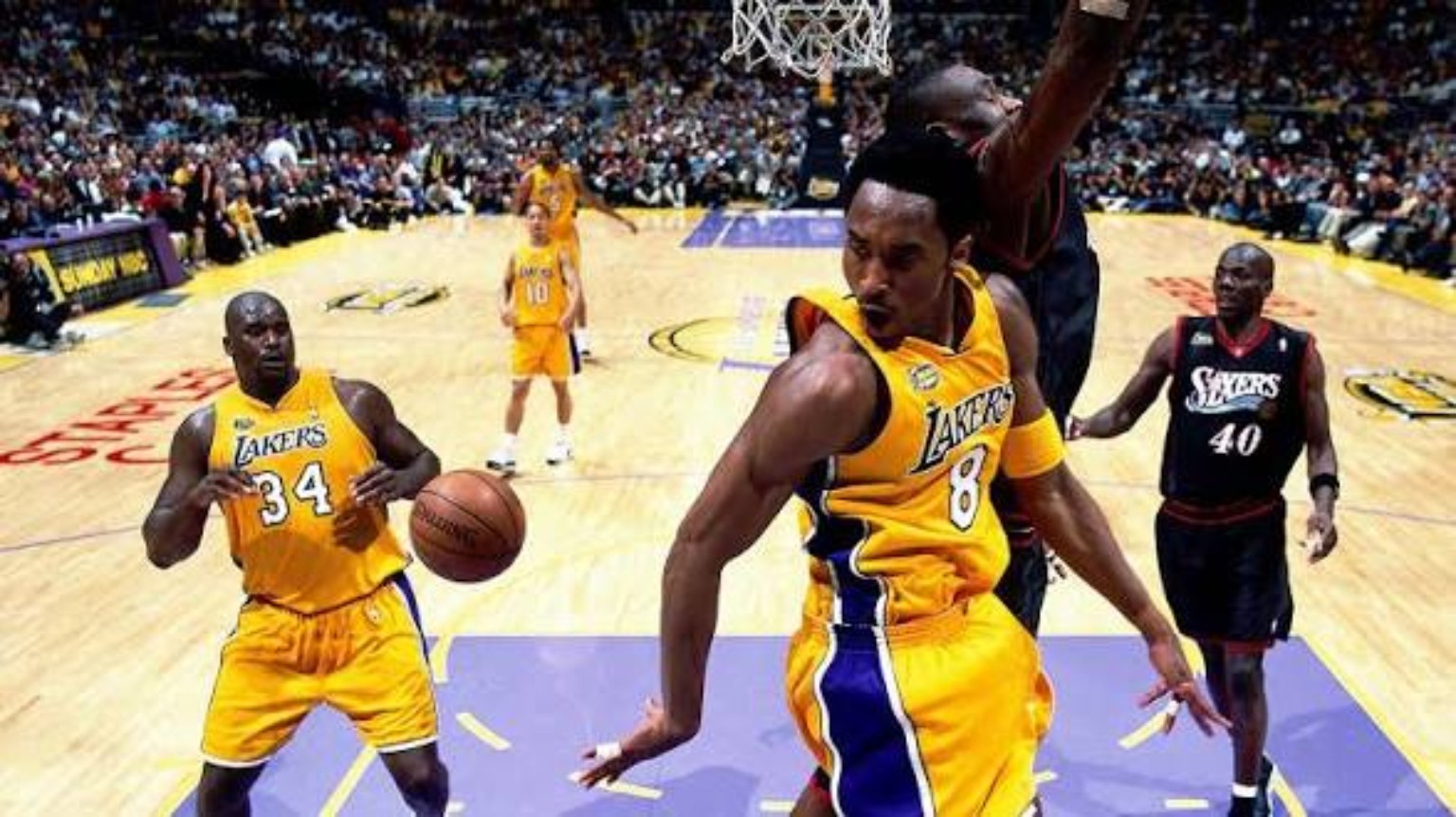 Kobe Bryant and Shaquille O'Neal in gold Lakers uniforms during the 2001 NBA Finals against Philadelphia