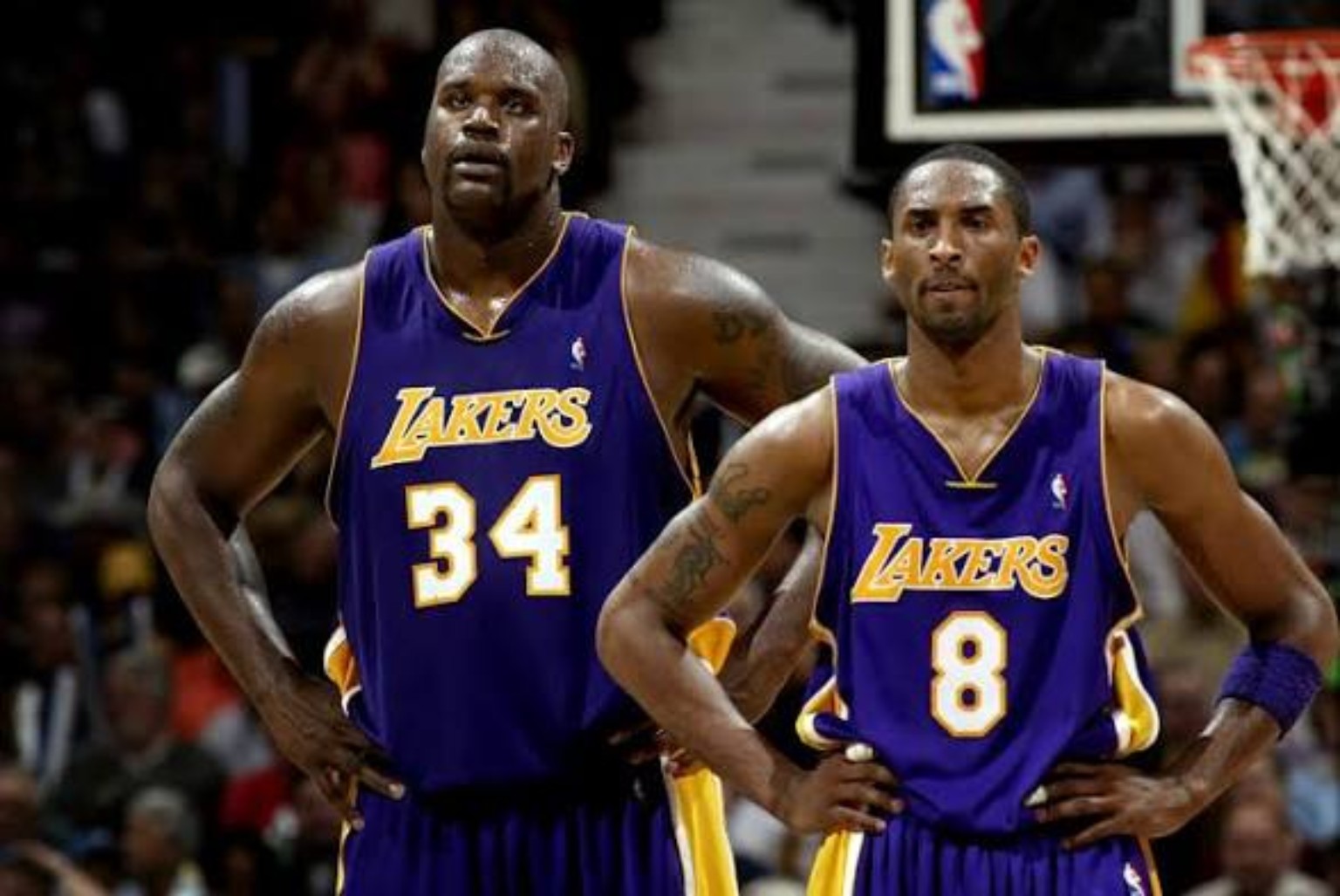 Shaquille O'Neal and Kobe Bryant standing together in purple Los Angeles Lakers uniforms