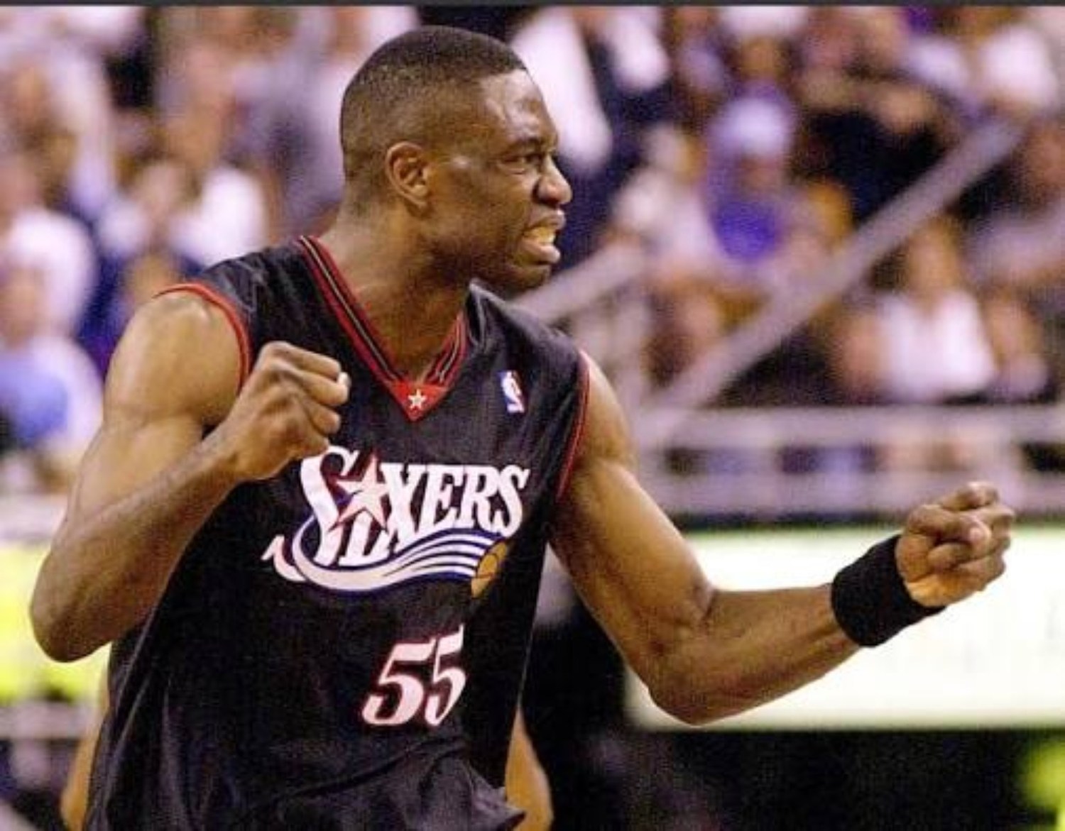 Philadelphia's veteran center celebrating in a black Sixers uniform